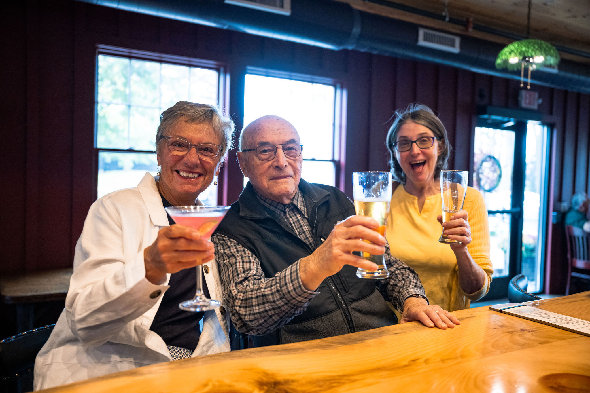 Three Guests Raising Their Drinks in The Tavern